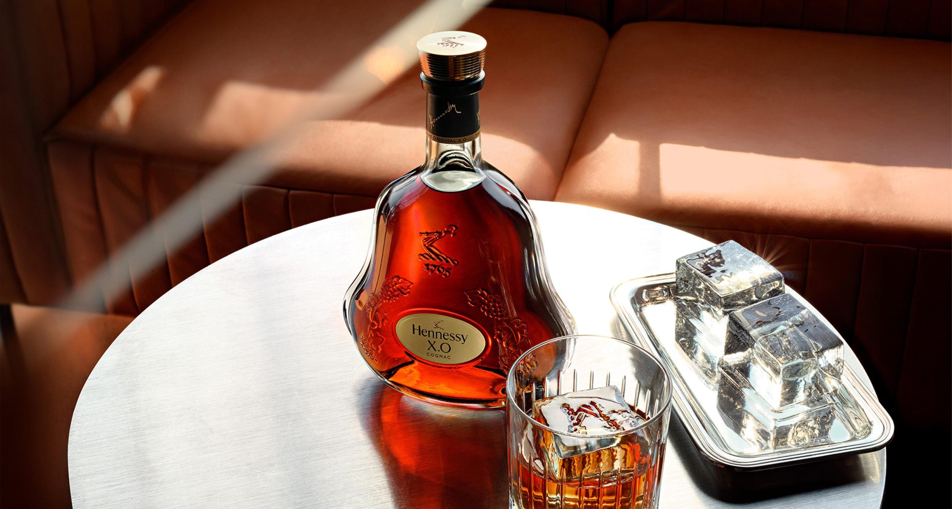 Hennessy X.O on a lounge table in warm light