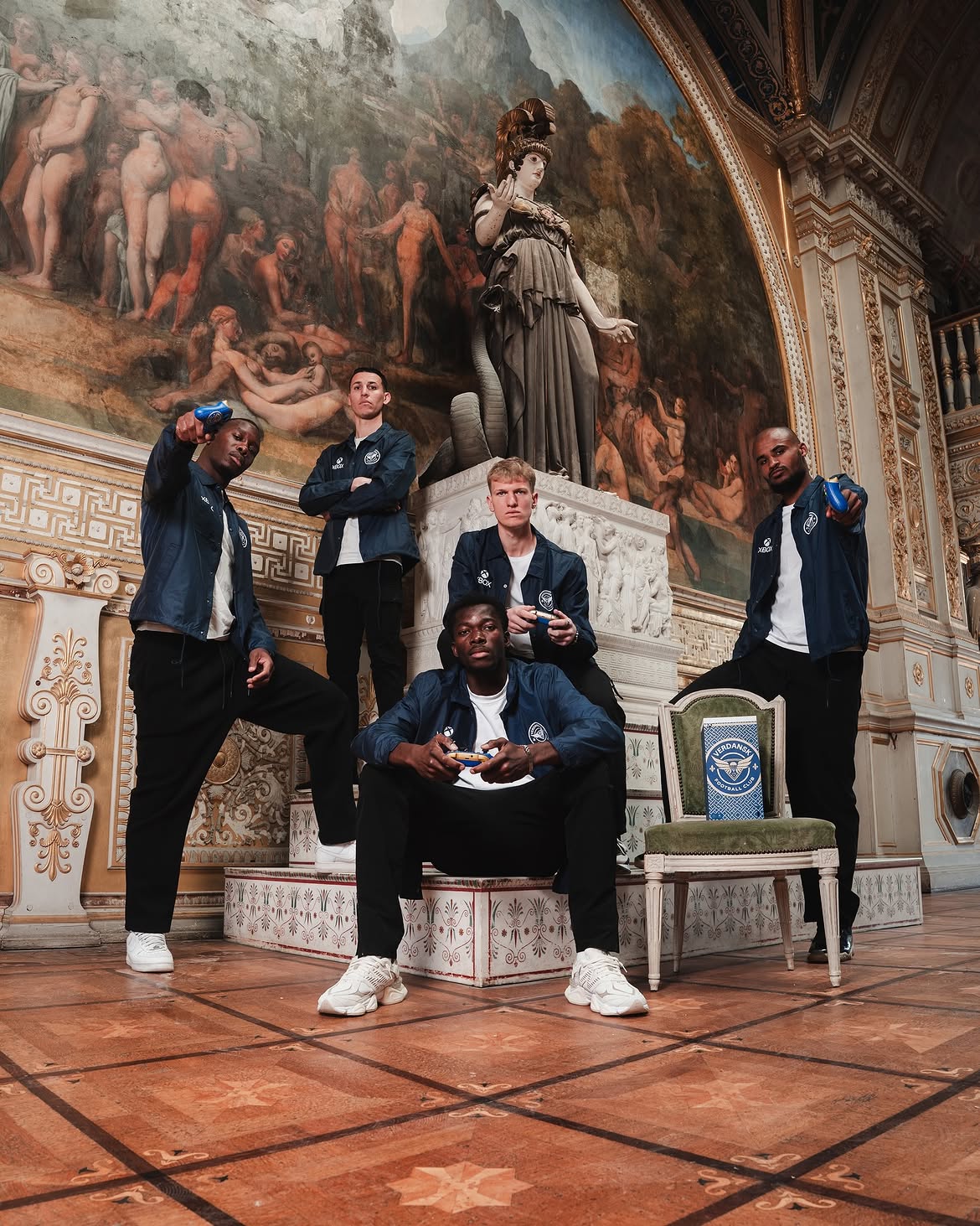 The FC Verdansk squad posing in a painted gallery with the console on a chair
