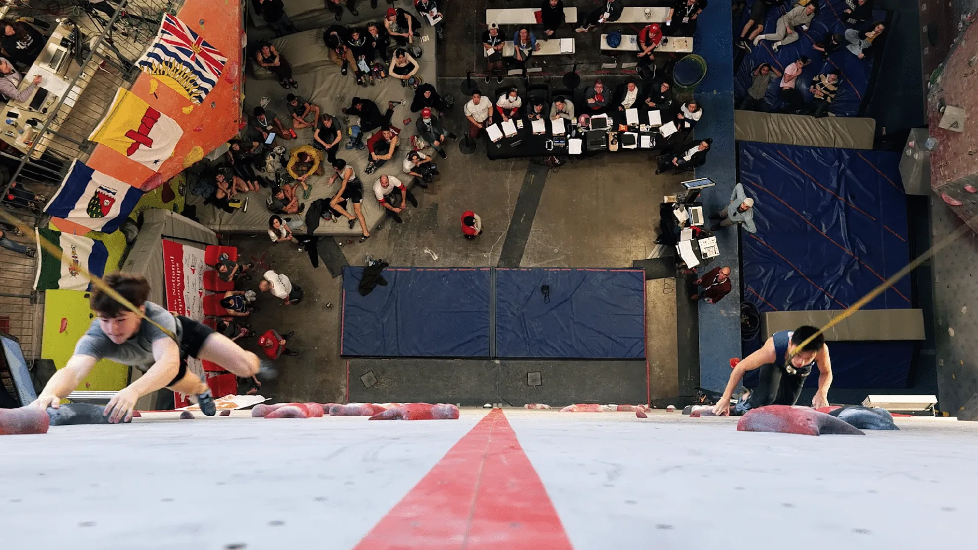 Overhead view of two athletes racing up the speed wall