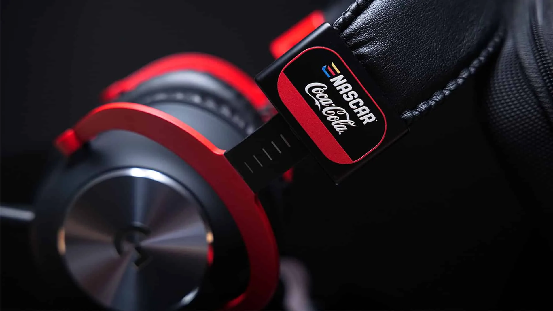 Detail of the red headband and NASCAR × Coca-Cola badge